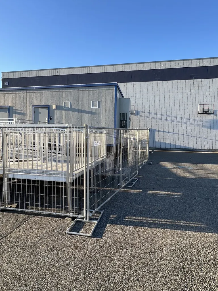 Anti-climb temporary fence panels surrounding an elevated access ramp in Pasco, Washington
