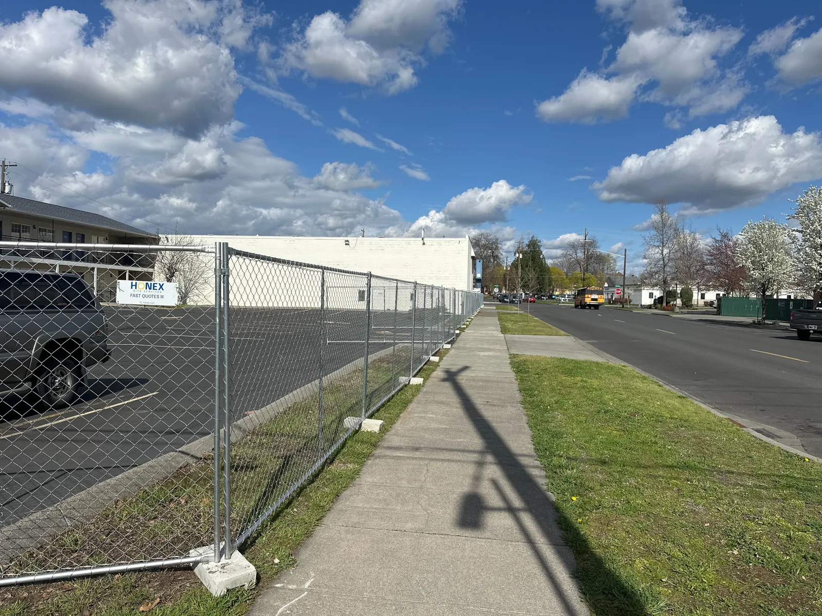 Temporary chain-link fence panels on concrete bases along a Walla Walla project perimeter.